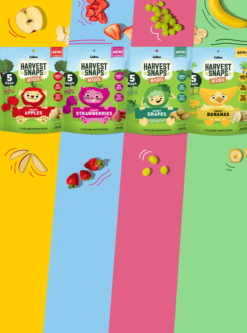 Harvest Snaps Kids - Crispy Strawberries, Crispy Apples, Crispy Grapes, Crispy Bananas with fruits as the background