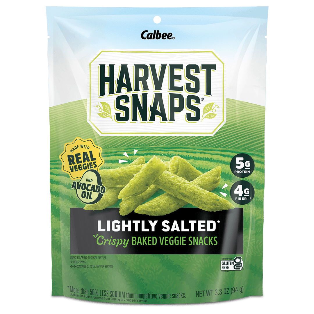 A bag of Calbee Harvest Snaps Lightly Salted Crispy Baked Veggie Snacks, featuring green vegetable-shaped snacks on the front of the packaging.