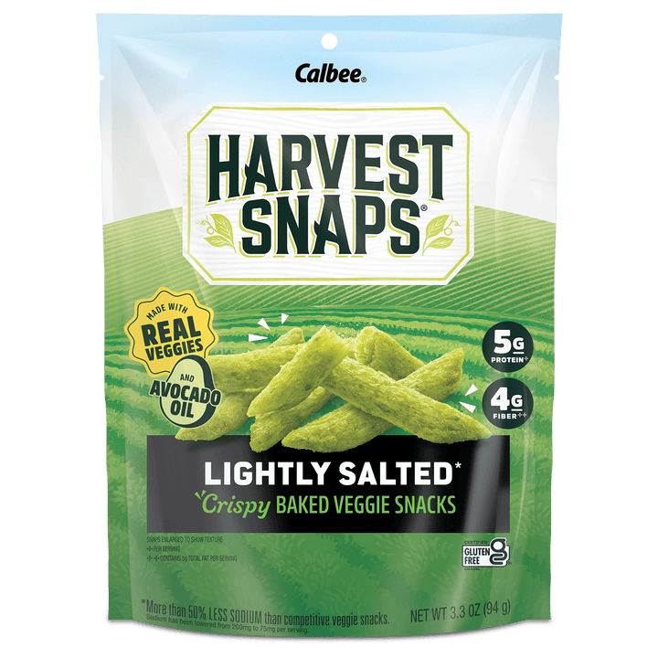A bag of Calbee Harvest Snaps Lightly Salted Crispy Baked Veggie Snacks, featuring green vegetable-shaped snacks on the front of the packaging.