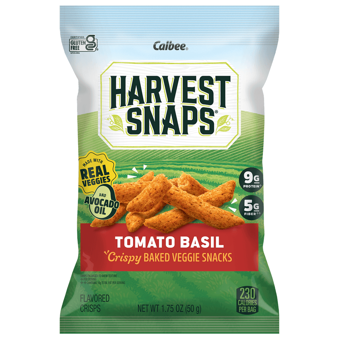 A bag of Calbee Harvest Snaps Tomato Basil crispy baked veggie snacks, featuring a green and white package design with an illustration of the golden-brown snack sticks.