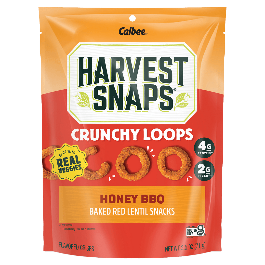 Bag of Harvest Snaps Crunchy Loops in Honey BBQ flavor. Features icons for real veggies, 4g protein, 2g fiber, and gluten-free on a bright red design.