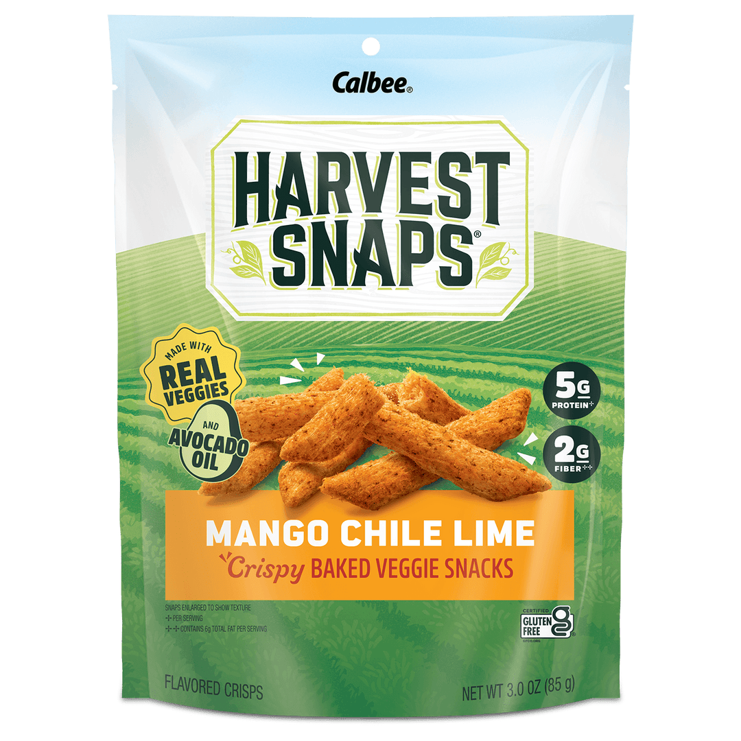 A package of Calbee Harvest Snaps Mango Chile Lime flavored crispy baked veggie snacks. The bag is green and white with an illustration of golden-brown snack sticks, and features badges indicating it is made with real vegetables and avocado oil.
