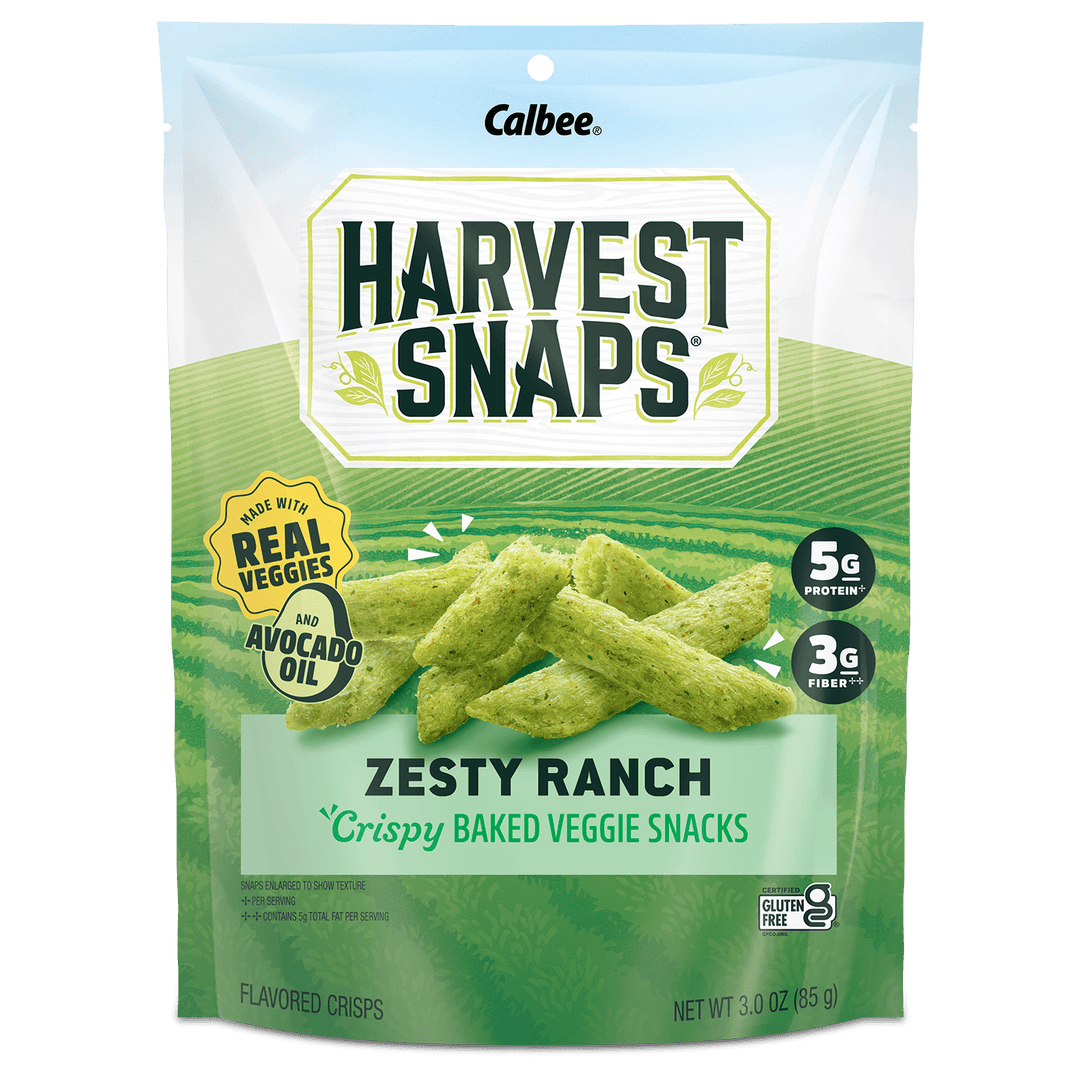 A 3.0 oz bag of Calbee Harvest Snaps Zesty Ranch crispy baked veggie snacks, featuring green chip illustrations on a green and white package.